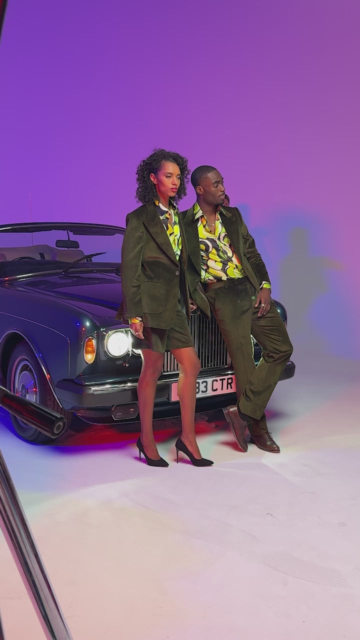 2 models wearing green corduroy suits and vibrant green silk shirts
